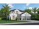 Two-story home with modern design, two-car garage, and palm trees at 2260 Mulbry Dr, Winter Park, FL 32789