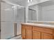 Bright bathroom featuring double vanity and a shower at 2325 Crossandra St, Mascotte, FL 34753