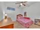 Charming bedroom with a pink camo comforter and wooden furniture at 2325 Crossandra St, Mascotte, FL 34753