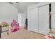 bedroom with a spacious closet and playful decor at 2325 Crossandra St, Mascotte, FL 34753
