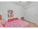 bedroom with pink bedding and double doors at 2325 Crossandra St, Mascotte, FL 34753