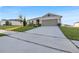 House with attached garage and a long driveway at 2325 Crossandra St, Mascotte, FL 34753