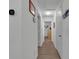 Bright hallway with light wood flooring and neutral walls at 2325 Crossandra St, Mascotte, FL 34753