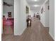 Bright hallway with laminate flooring, leading to living area and bedroom at 2325 Crossandra St, Mascotte, FL 34753