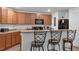 Modern kitchen with wooden cabinets and breakfast bar at 2325 Crossandra St, Mascotte, FL 34753