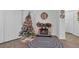 Cozy living room with fireplace and Christmas tree at 2325 Crossandra St, Mascotte, FL 34753