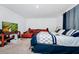 Primary bedroom with a king-size bed and orange couch at 2362 Lancashire St, Davenport, FL 33896