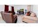 Living room with brown leather couches and a glass coffee table at 2362 Lancashire St, Davenport, FL 33896