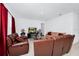 Living room with brown leather couches and a glass coffee table at 2362 Lancashire St, Davenport, FL 33896