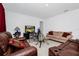 Living room with brown leather couches and a glass coffee table at 2362 Lancashire St, Davenport, FL 33896