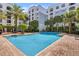 Inviting rectangular pool surrounded by a brick patio and palm trees at 304 E South St # 2022, Orlando, FL 32801