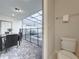 Small bathroom with toilet and view of the patio with pool at 4190 Lana Ave, Davenport, FL 33897