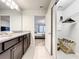 Bathroom with granite countertop, dark brown vanity, and a view of the bedroom at 4190 Lana Ave, Davenport, FL 33897