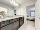 Double sink bathroom with granite countertop and dark brown vanity at 4190 Lana Ave, Davenport, FL 33897