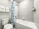 Bathroom with a tub and whale-themed shower curtain at 4190 Lana Ave, Davenport, FL 33897