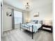 Cozy bedroom with a metal bed frame and a window with blinds at 4190 Lana Ave, Davenport, FL 33897