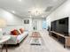 Spacious bonus room features a comfy couch, large TV, and plenty of natural light at 4190 Lana Ave, Davenport, FL 33897