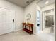 Home entryway with a mid-century modern console table and view of bathroom at 4190 Lana Ave, Davenport, FL 33897