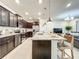 Modern kitchen with dark brown cabinets, granite counters, and island at 4190 Lana Ave, Davenport, FL 33897