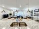 Kitchen island with granite countertop, sink, and seating at 4190 Lana Ave, Davenport, FL 33897