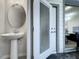 Small powder room with pedestal sink and access to a patio at 4190 Lana Ave, Davenport, FL 33897