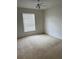 Spacious bedroom with carpet, ceiling fan, and window at 5542 Metrowest Blvd # 206, Orlando, FL 32811