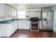 Renovated kitchen, featuring white cabinets, stainless steel appliances, and dark countertops at 577 Maxey Ave, Winter Garden, FL 34787