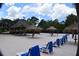 Relaxing beach area with thatched umbrellas, lounge chairs, and lush landscaping at 605 Rum Run # 605, Davenport, FL 33837