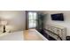 Comfortable bedroom with a queen/full-size bed, dresser, TV, and window view at 605 Rum Run # 605, Davenport, FL 33837