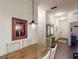 Dining area with wooden table, white chairs, and entryway with mirror and console table at 605 Rum Run # 605, Davenport, FL 33837