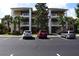 Attractive three-story condo building with balconies and parking lot at 605 Rum Run # 605, Davenport, FL 33837