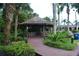 Thatched gazebo with seating, surrounded by tropical plants and landscaping at 605 Rum Run # 605, Davenport, FL 33837