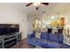 Inviting living room with comfortable blue couch, fireplace, and view of the kitchen at 605 Rum Run # 605, Davenport, FL 33837