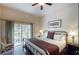 Spacious main bedroom with king-size bed, patio access, and ensuite bathroom at 605 Rum Run # 605, Davenport, FL 33837