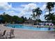 Large community pool with plenty of space for swimming and lounging, surrounded by palm trees at 605 Rum Run # 605, Davenport, FL 33837