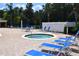 Community pool, hot tub, lounge chairs, and patio umbrella at 605 Rum Run # 605, Davenport, FL 33837