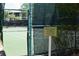 Tennis court with basketball hoop and community signage at 605 Rum Run # 605, Davenport, FL 33837