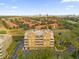 Condo building's exterior, aerial view showing its location and surroundings at 7500 Toscana Blvd # 333, Orlando, FL 32819