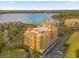Drone view of a residential building complex, showcasing its location near a lake at 7500 Toscana Blvd # 333, Orlando, FL 32819