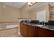 Bathroom with double vanity, soaking tub, and shower at 7500 Toscana Blvd # 333, Orlando, FL 32819