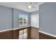Bedroom with hardwood floors and large window with blinds at 7500 Toscana Blvd # 333, Orlando, FL 32819