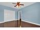 Bedroom with hardwood floors, double doors, and access to bathroom at 7500 Toscana Blvd # 333, Orlando, FL 32819
