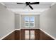 Bedroom with hardwood floors and two windows at 7500 Toscana Blvd # 333, Orlando, FL 32819