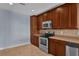 Kitchen with stainless steel appliances and wood cabinets at 7500 Toscana Blvd # 333, Orlando, FL 32819