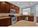 Modern kitchen with stainless steel appliances and wood cabinets at 7500 Toscana Blvd # 333, Orlando, FL 32819
