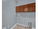 Laundry room with wood cabinets and built-in shelving at 7500 Toscana Blvd # 333, Orlando, FL 32819