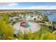 Aerial view of the community water park with slides, splash pad, and pool at 826 Paradise Dr, Davenport, FL 33897