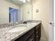 Modern bathroom with double vanity, granite countertop, and large mirror at 826 Paradise Dr, Davenport, FL 33897