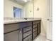 Double vanity bathroom with granite countertop and dark brown cabinets at 826 Paradise Dr, Davenport, FL 33897