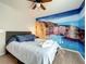 Bedroom with beach mural and ceiling fan at 826 Paradise Dr, Davenport, FL 33897